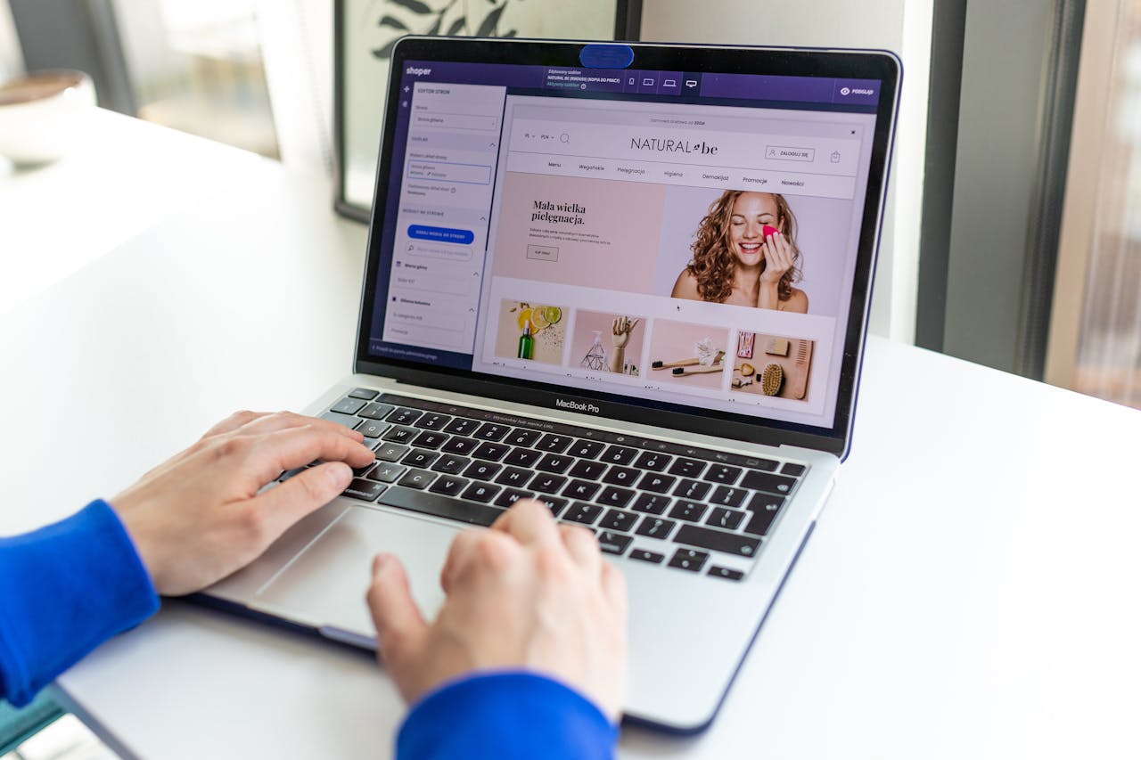 our-story Hands typing on a laptop with an e-commerce website open, showcasing online shopping.